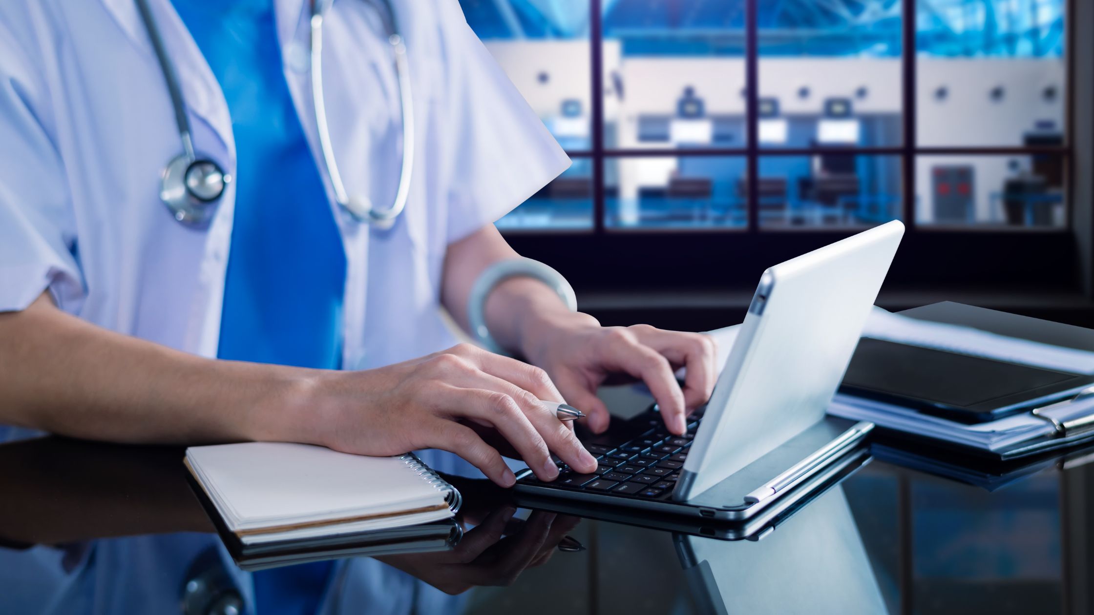 OnClik IPA- Intelligent Process Automation for Healthcare Industry. Doctor using a laptop.