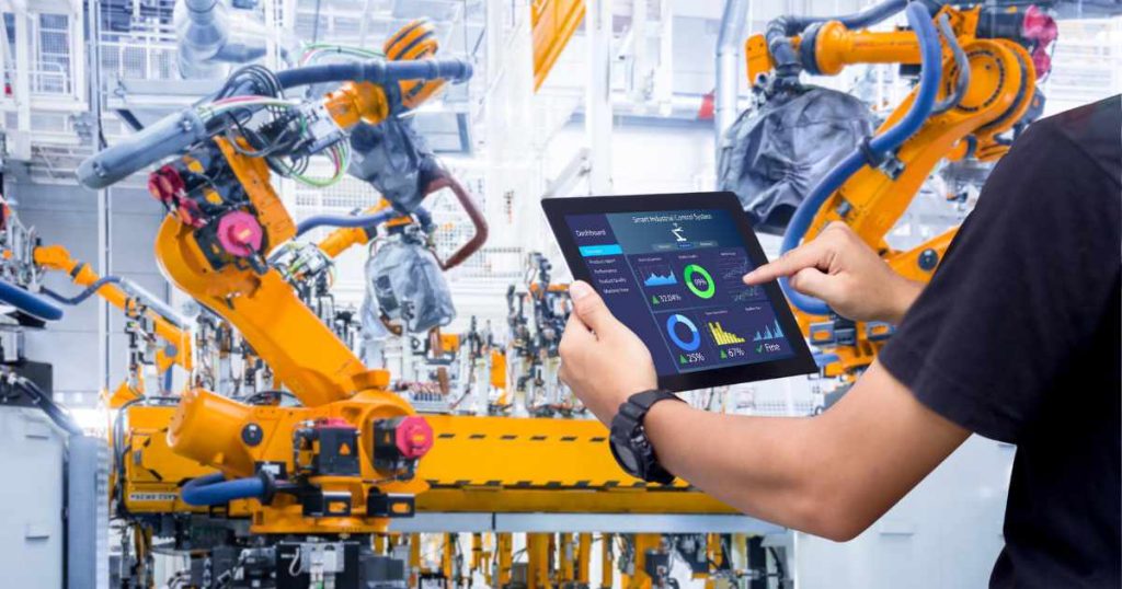 Inside automotive industry and a man using tablet to automate processes.